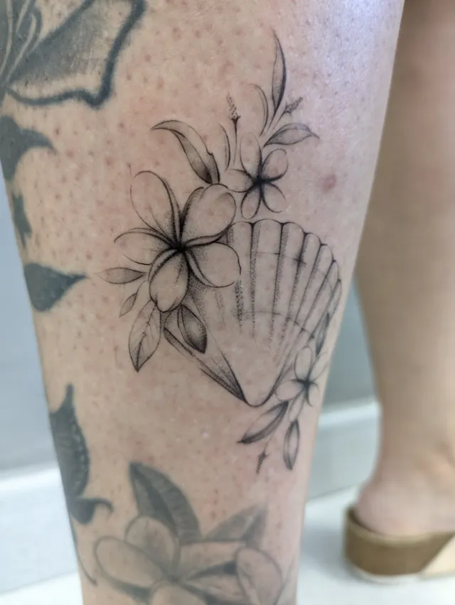 Fine line tattoo: flowers and shell