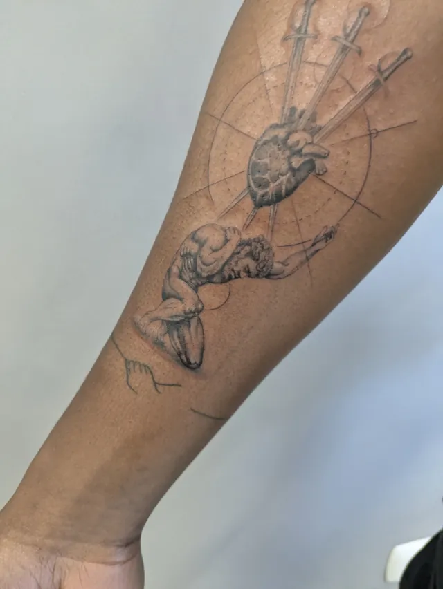 Tattoo: anatomical heart and compass